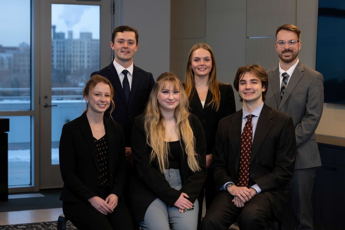 Five college students and three faculty advisors posing together after NASA technology presentation