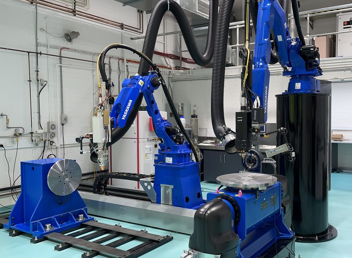 Researcher examining intricate metal component created through 3D printing technology at Lab22 facility