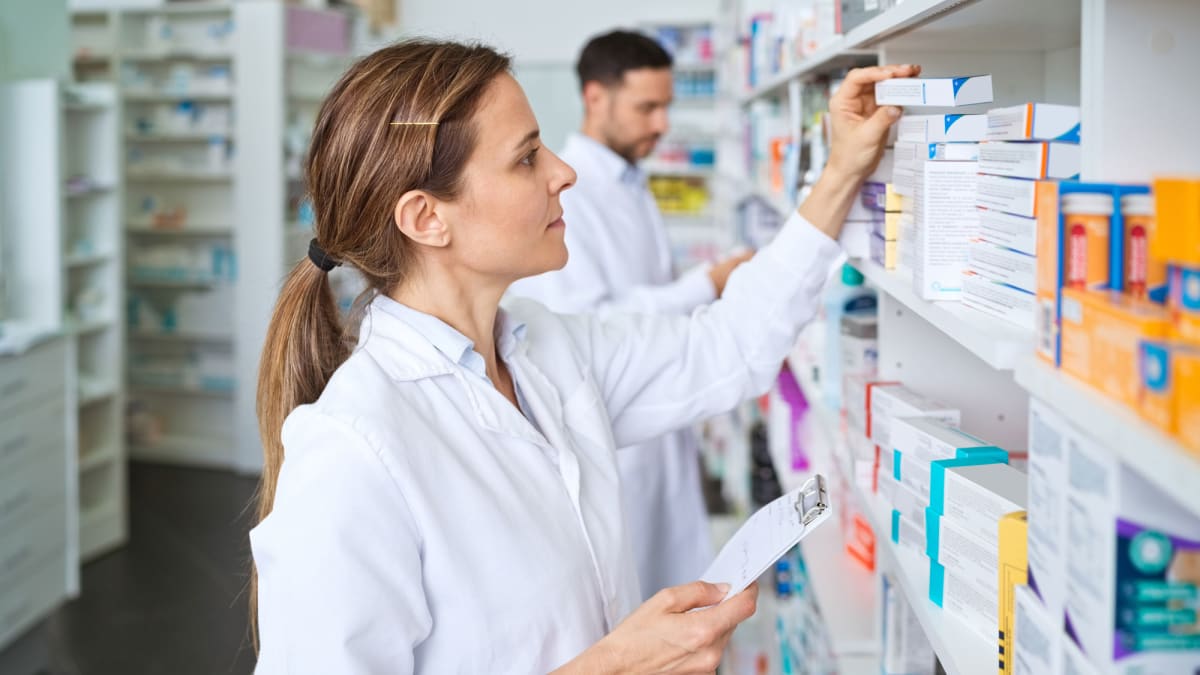 Medical research laboratory with scientists examining new pharmaceutical treatments for patients