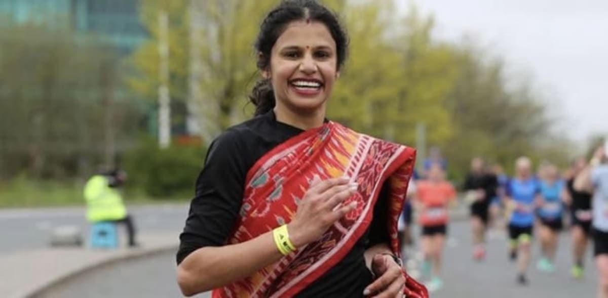 Teacher Madhusmita Jena running a marathon wearing a traditional Indian saree