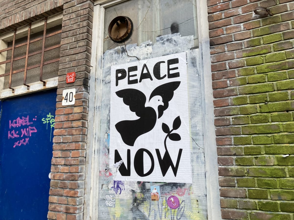 Dutch government building with European and Netherlands flags symbolizing restored humanitarian aid commitment