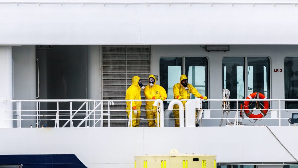 Cleaners in protective gear disinfecting the Hondius cruise ship docked at Rotterdam port
