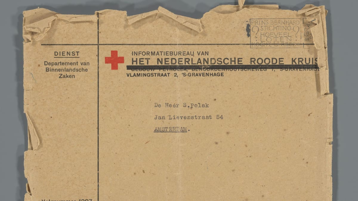 ** Concentration camp coat with name sewn in collar displayed in museum glass case