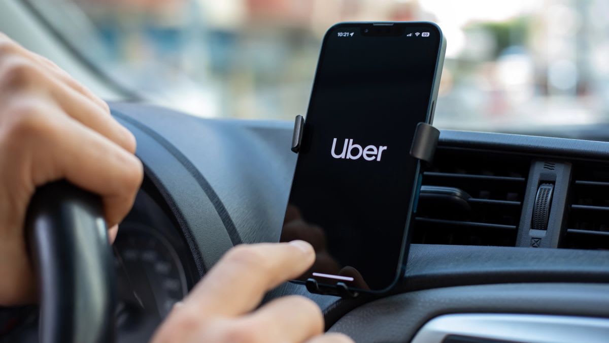 Uber app logo on smartphone screen representing gig economy platform regulation and worker protections