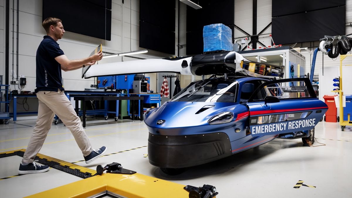 PAL-V Liberty flying car prototype with folded rotor blades parked on ground in Raamsdonksveer