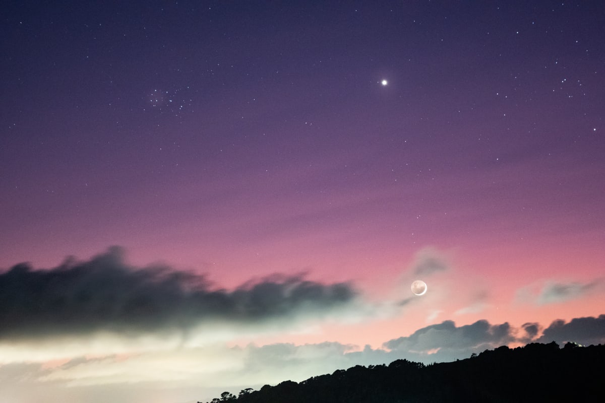 The Matariki star cluster glowing against the dark pre-dawn sky over New Zealand