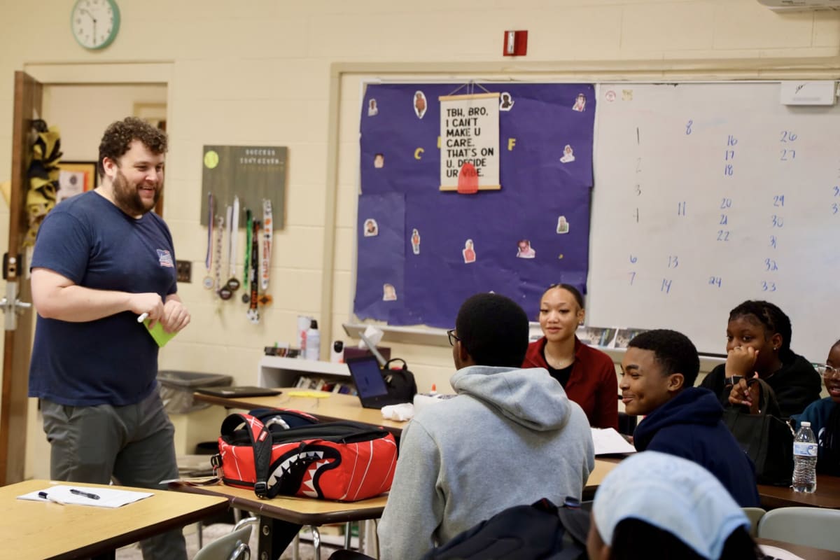 Teacher Charles Oliver standing in his Roanoke Valley Early College classroom with students