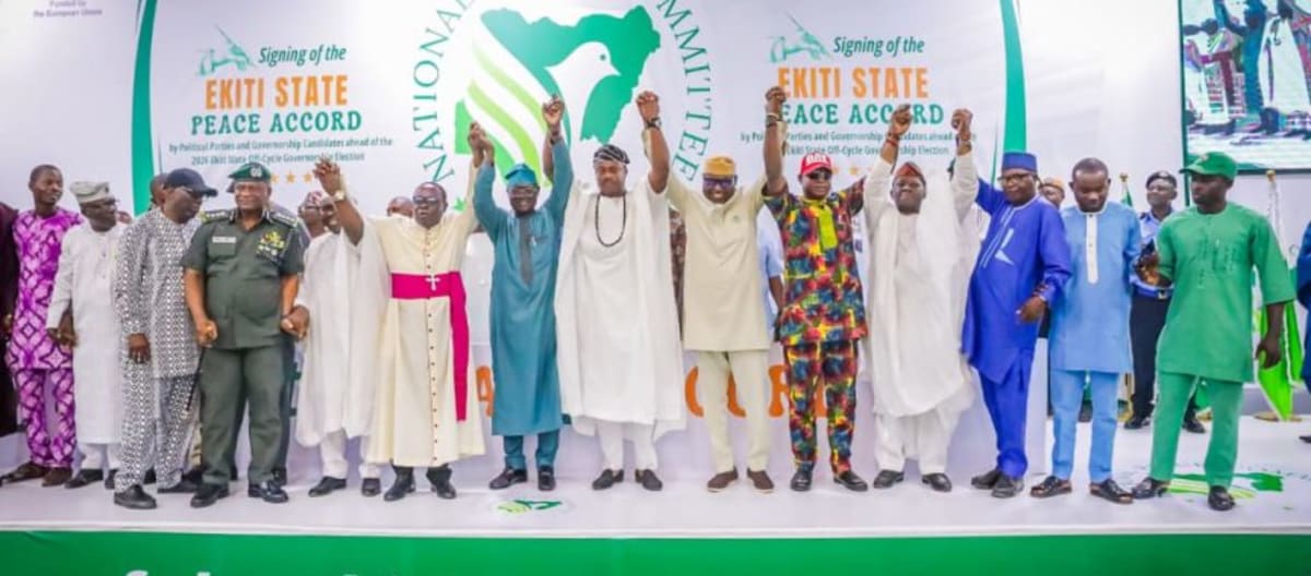 Nigerian political candidates signing peace accord document at ceremony in Ekiti State