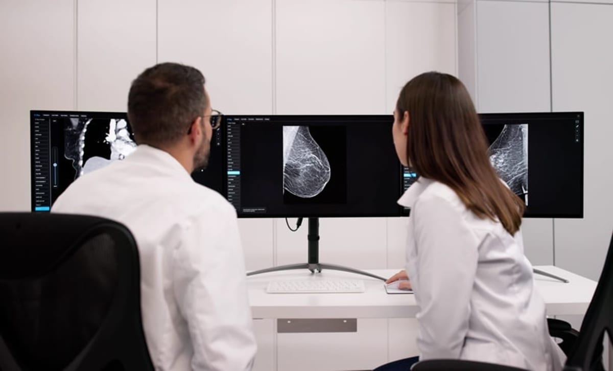 Scientist examining cancer research results in modern laboratory setting showing medical breakthrough