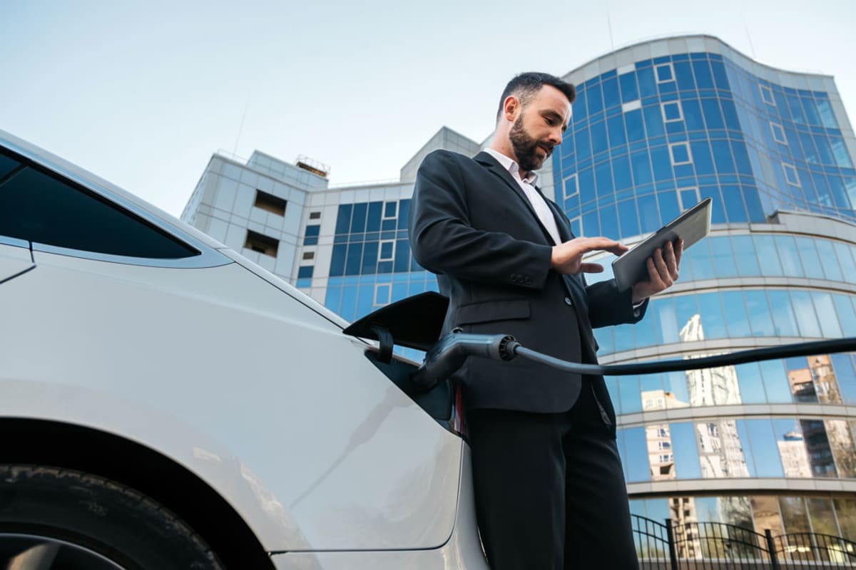 Modern electric vehicle being delivered to employee at workplace through salary benefit program