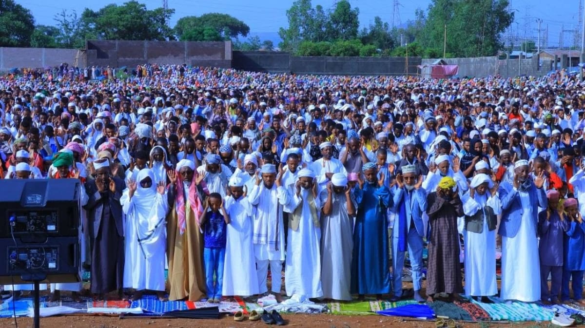 Large gathering of Muslim worshippers praying together at outdoor celebration in Ethiopia