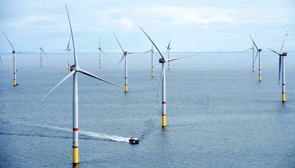 Offshore wind turbines standing tall in ocean waters generating renewable electricity for UK homes