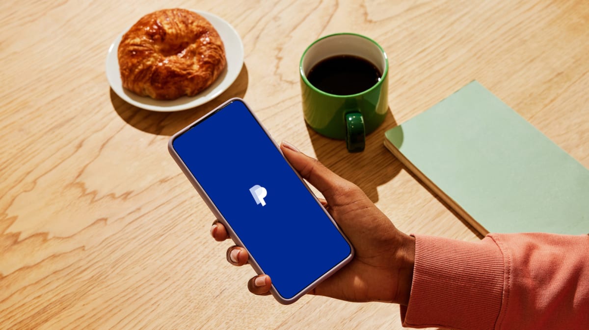 ** PayPal logo with small business owners celebrating financial support and growth opportunities