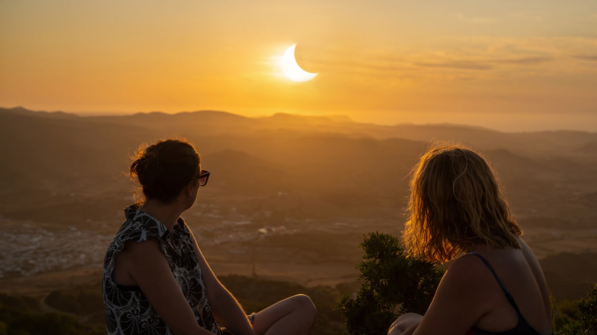 Total solar eclipse showing moon completely blocking sun with corona visible around edges