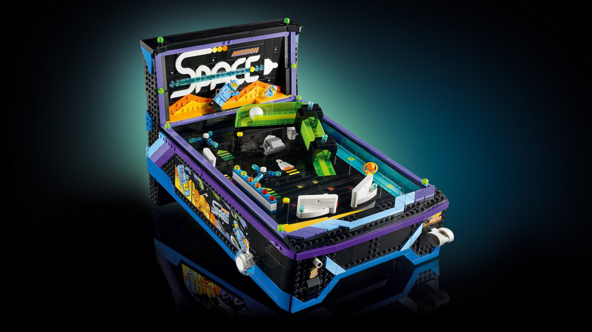 Colorful Lego pinball machine with space theme showing flippers and astronaut minifigures