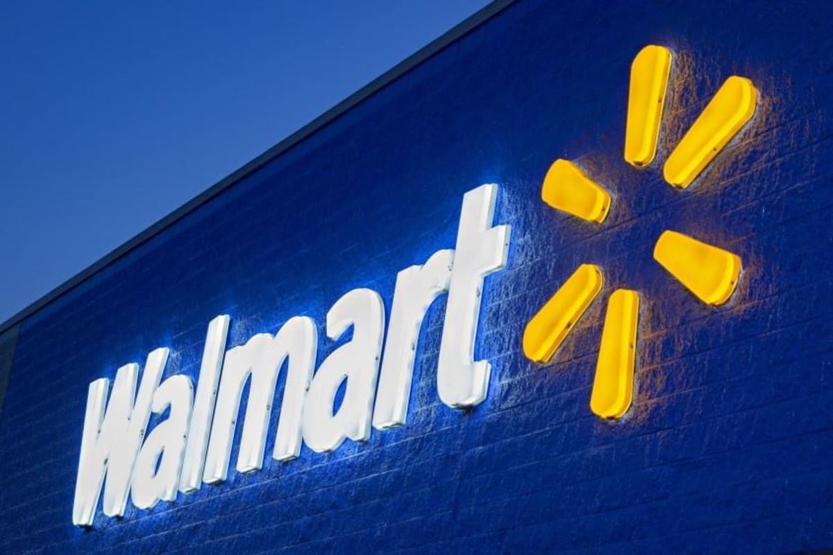 Walmart storefront with solar panels on roof representing clean energy commitment