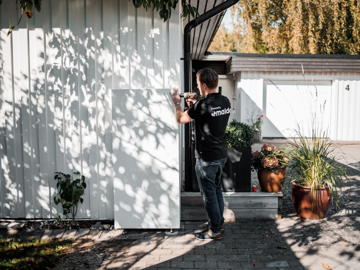 Modern home battery system mounted on residential wall in Swedish home interior