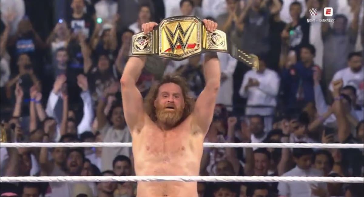 WWE wrestlers Kevin Owens and Sami Zayn together celebrating their friendship and championship success