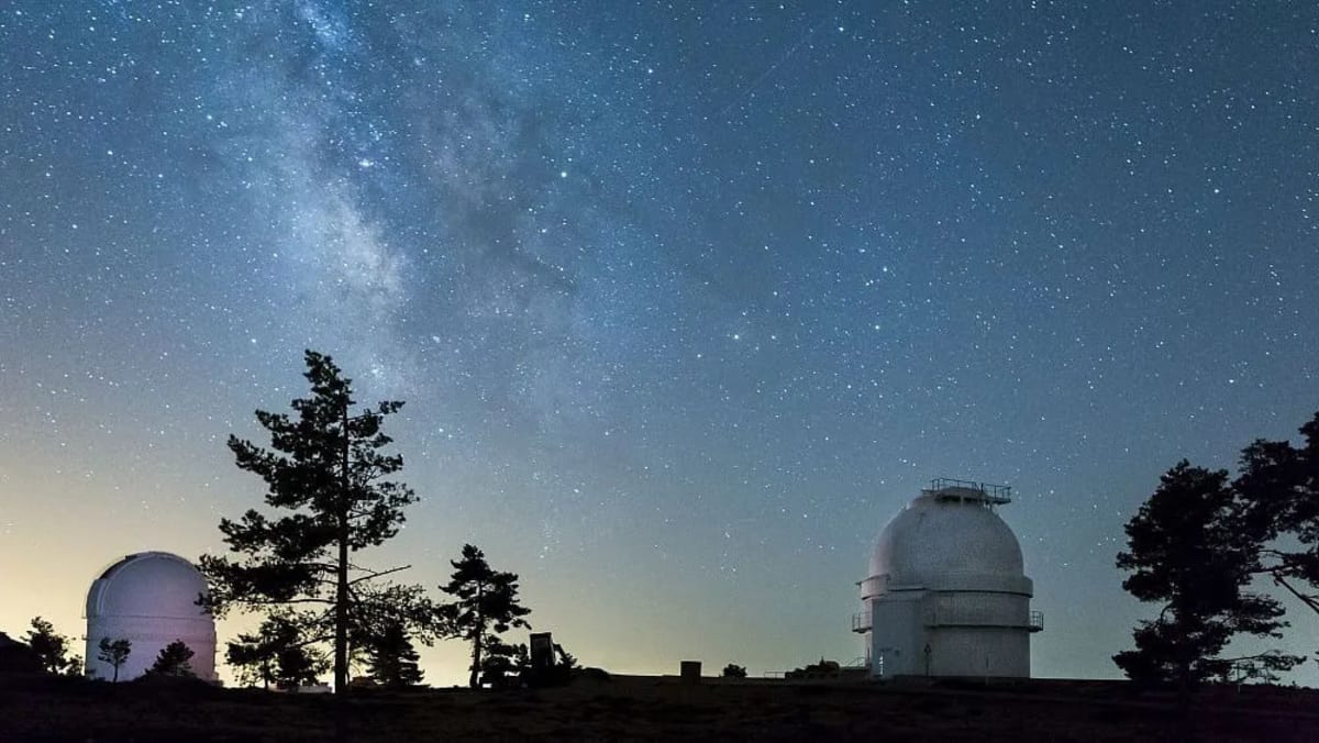 Modern astronomical telescope pointing toward starry night sky in Brazil observatory facility
