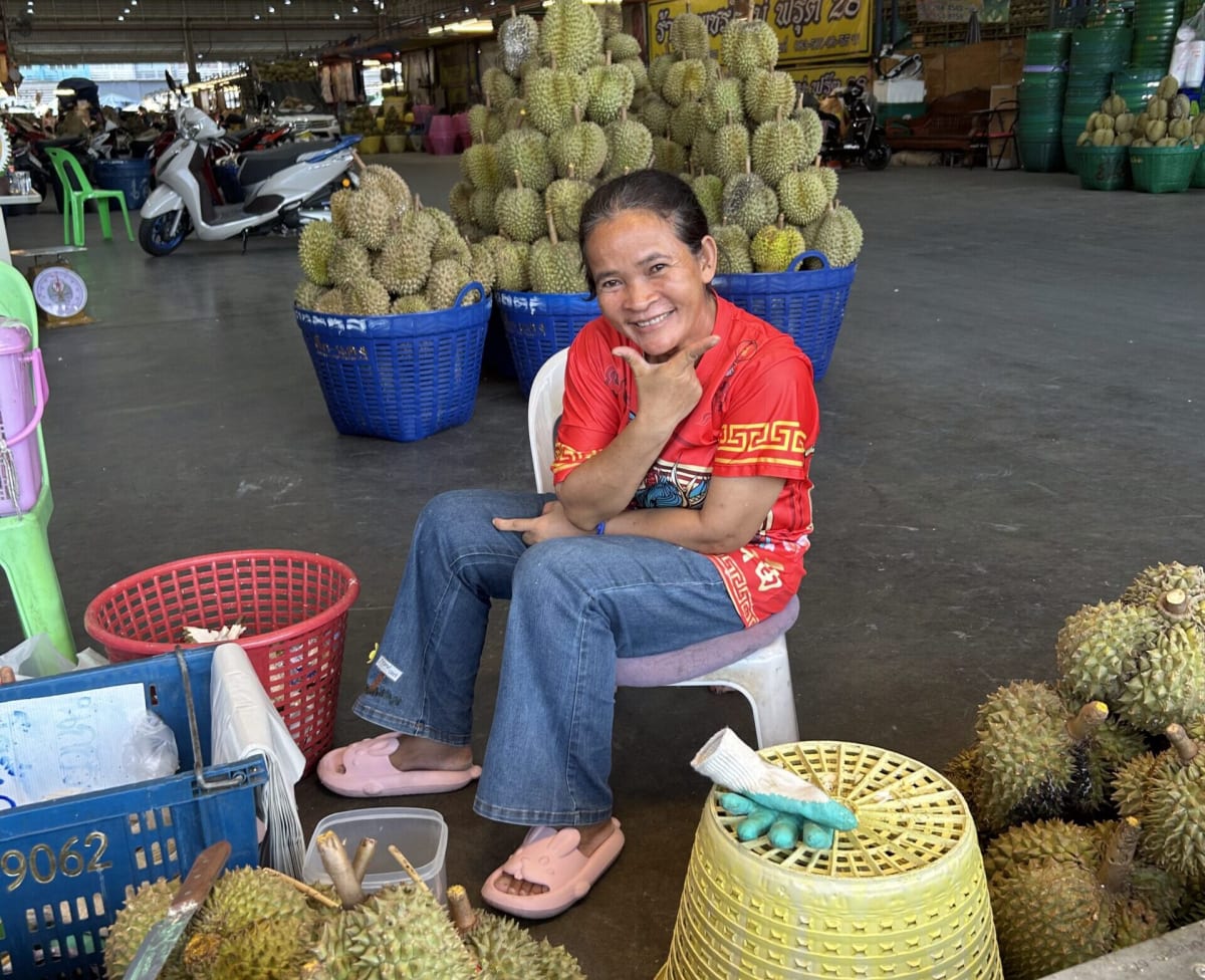 Colorful fresh produce and seafood displayed at bustling Talaad Thai market in Bangkok, Thailand
