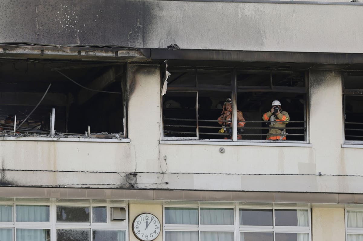 Firefighters work at Tokyo elementary school with smoke billowing from upper floor windows