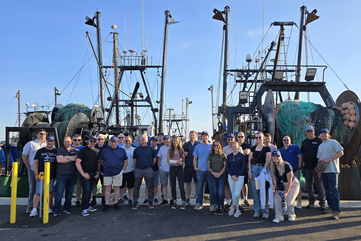 Scottish and American fishing industry members discussing collaborative ocean research at Rhode Island port facility