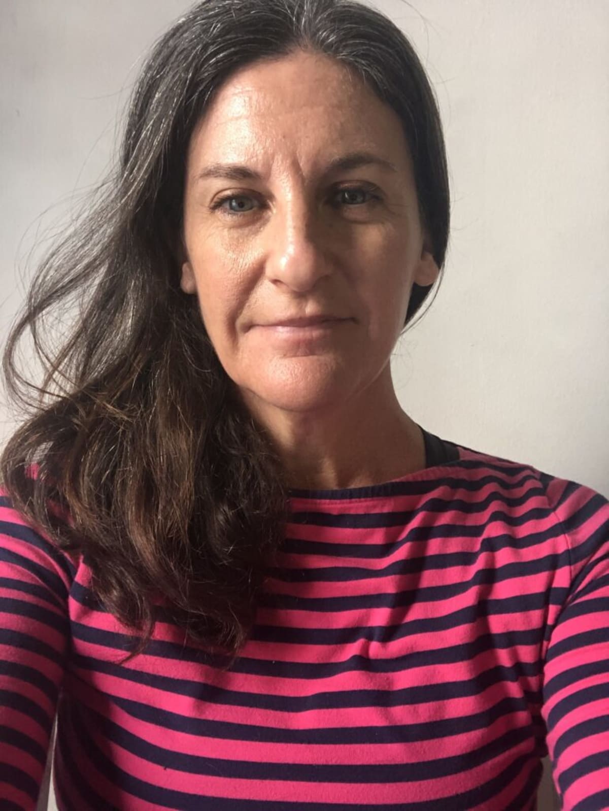Environmental educator Terran McGinnis standing on Florida beach with ocean and wildlife habitat visible
