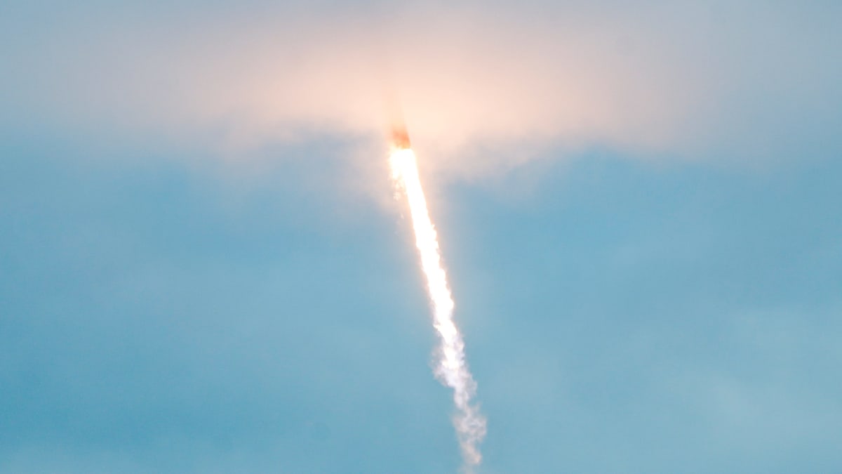 SpaceX Falcon 9 rocket launching from Cape Canaveral against blue Florida sky