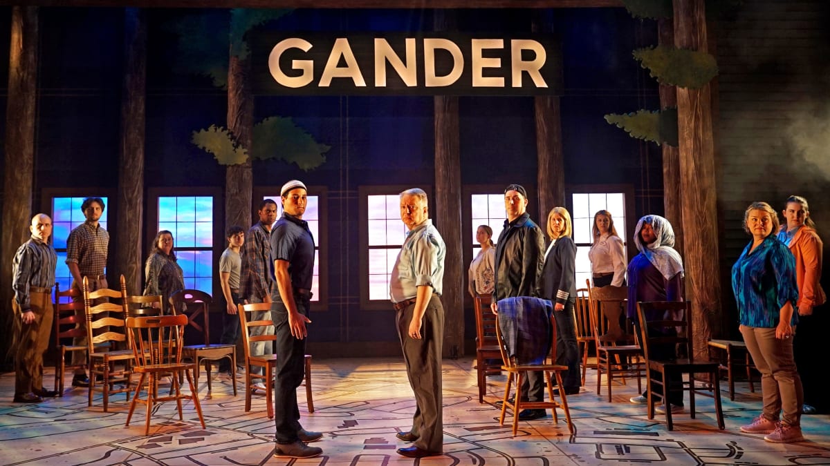 Theater audience watching Come From Away musical performance celebrating Gander's 9/11 hospitality