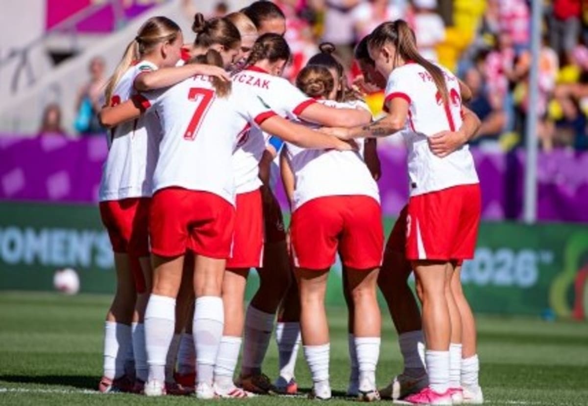 Polish women's soccer team celebrating together on field after historic first World Cup victory