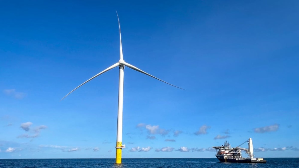 ** Offshore wind turbines spinning in Atlantic Ocean waters near Rhode Island coastline