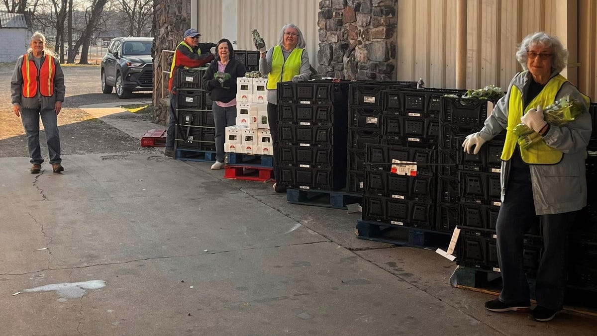 Volunteers distributing fresh food and groceries to families at rural Arkansas community food pantry