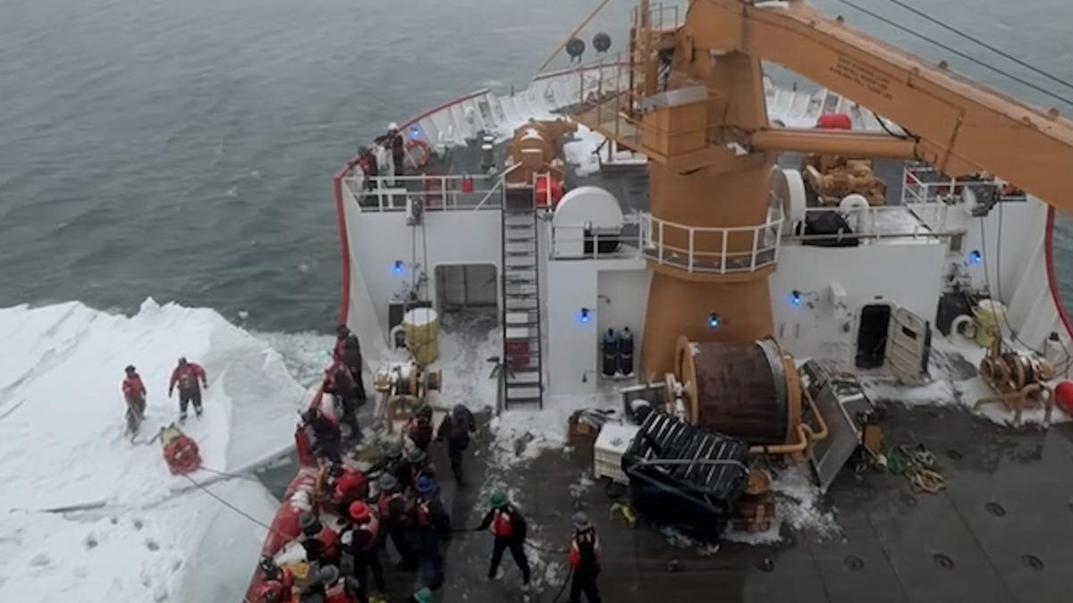 Coast Guard icebreaker vessel navigating through icy waters during rescue mission