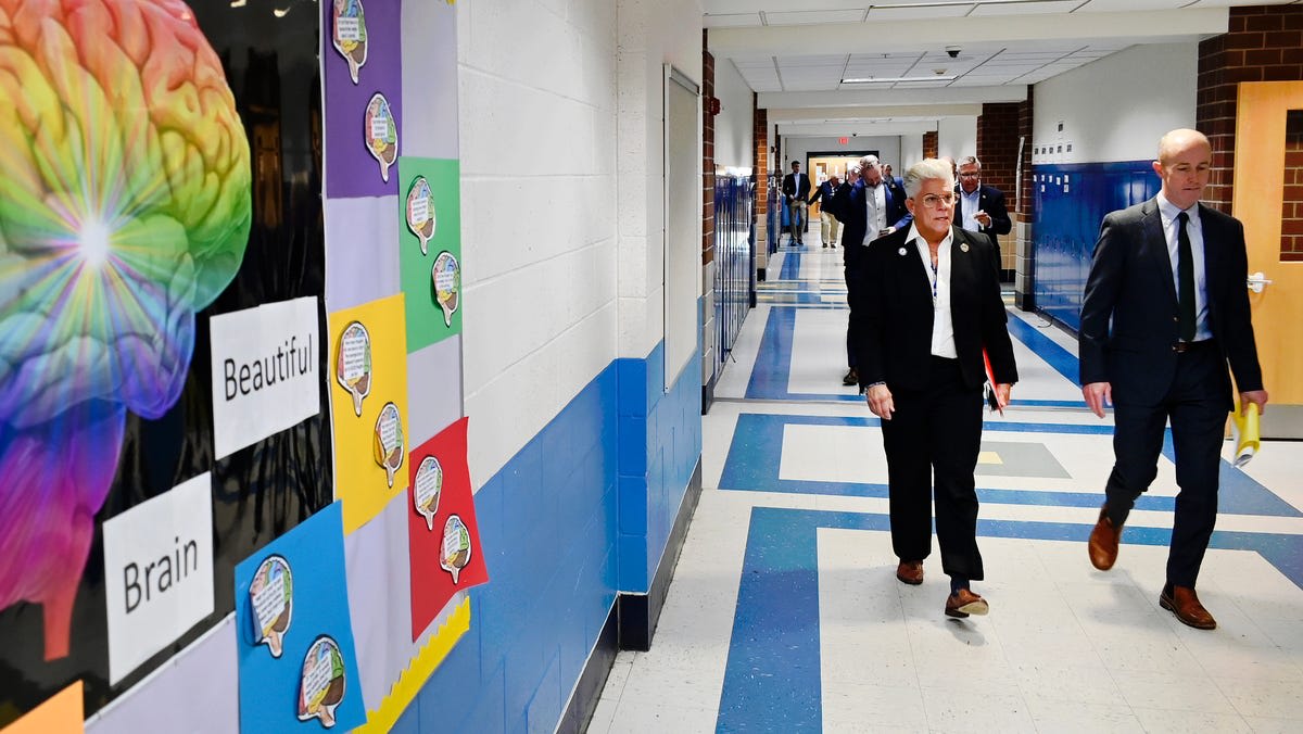 Students learning in a bright, modern elementary school classroom with updated ventilation systems