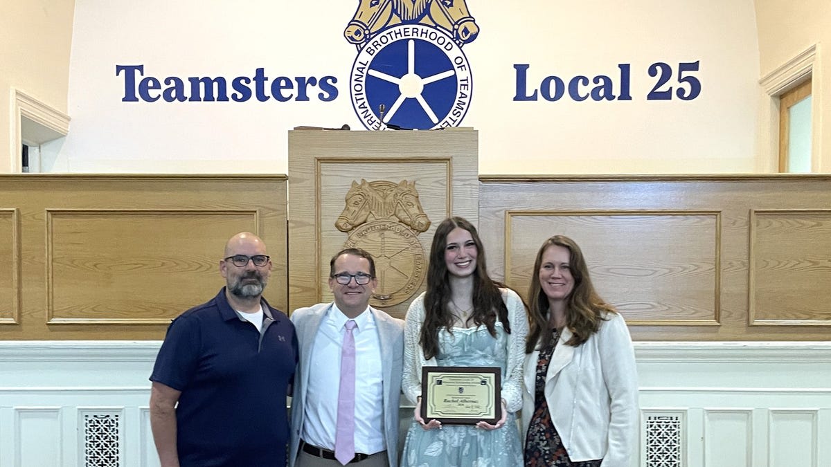 Rachel Albernaz holding scholarship award from Teamsters Local 25 union in Massachusetts