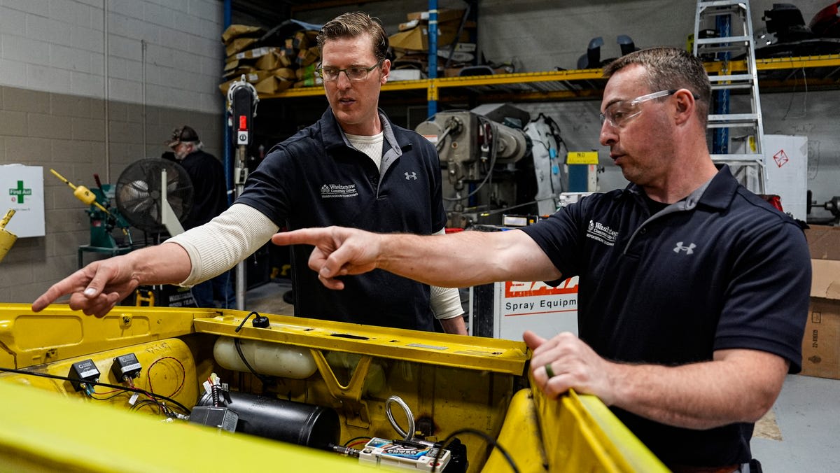 Students working on restoring vintage 1974 Volkswagen Thing convertible at Michigan automotive college workshop