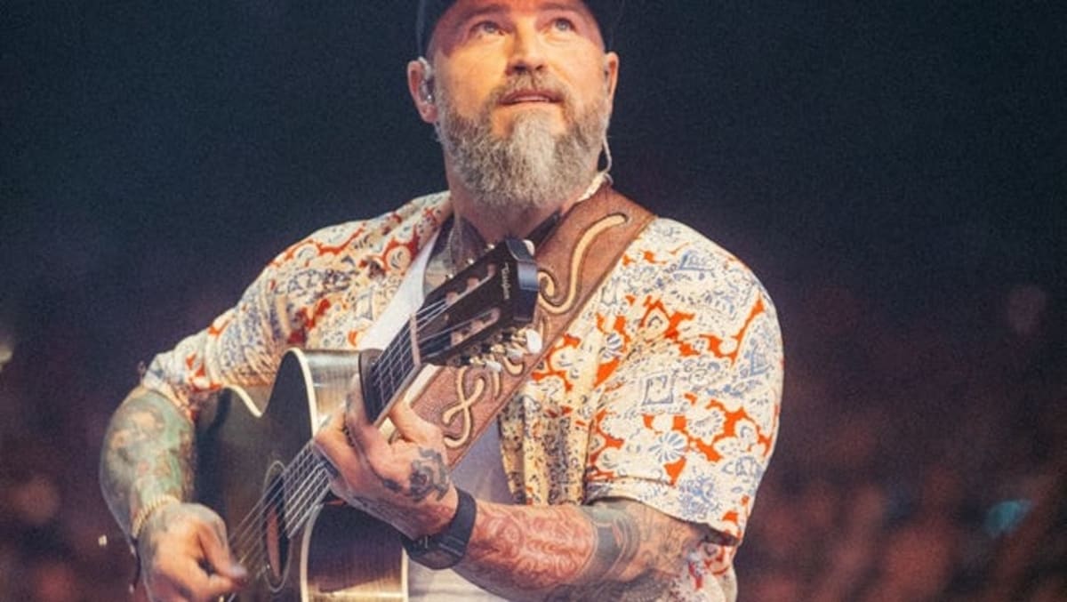 Zac Brown performing on stage at Fenway Park baseball stadium in Boston