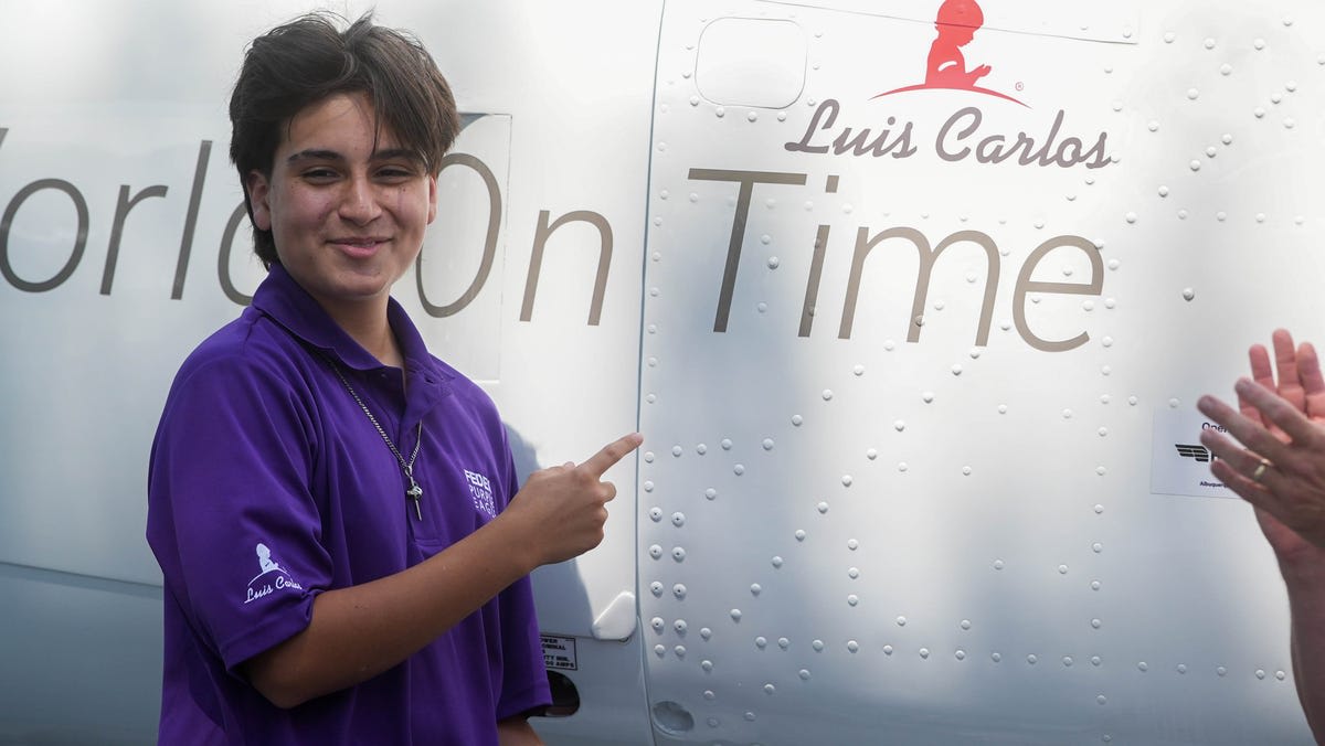 Fifteen-year-old Luis Carlos smiling at FedEx St. Jude Championship Purple Eagle plane ceremony
