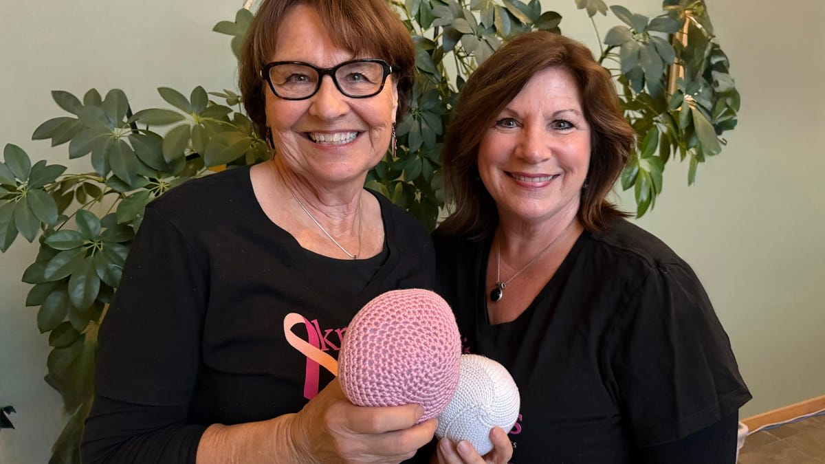 Colorful handmade knitted breast prosthetics arranged together showing the craftsmanship of volunteers