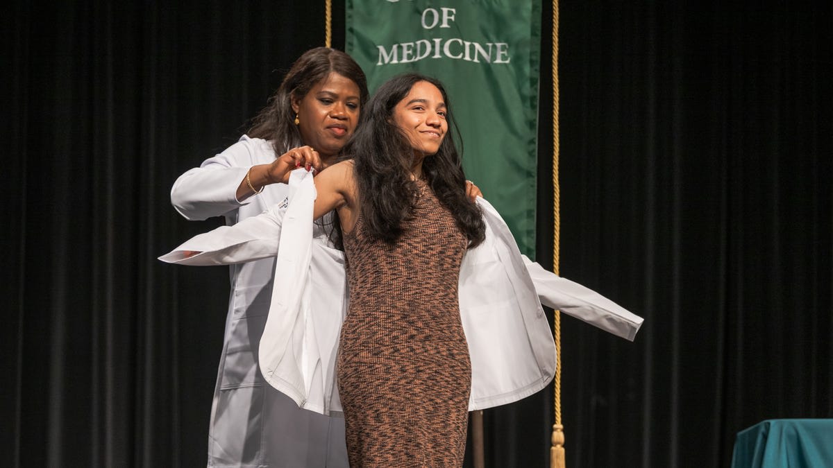 Medical students in white coats celebrating at Methodist University's first white coat ceremony in Fayetteville