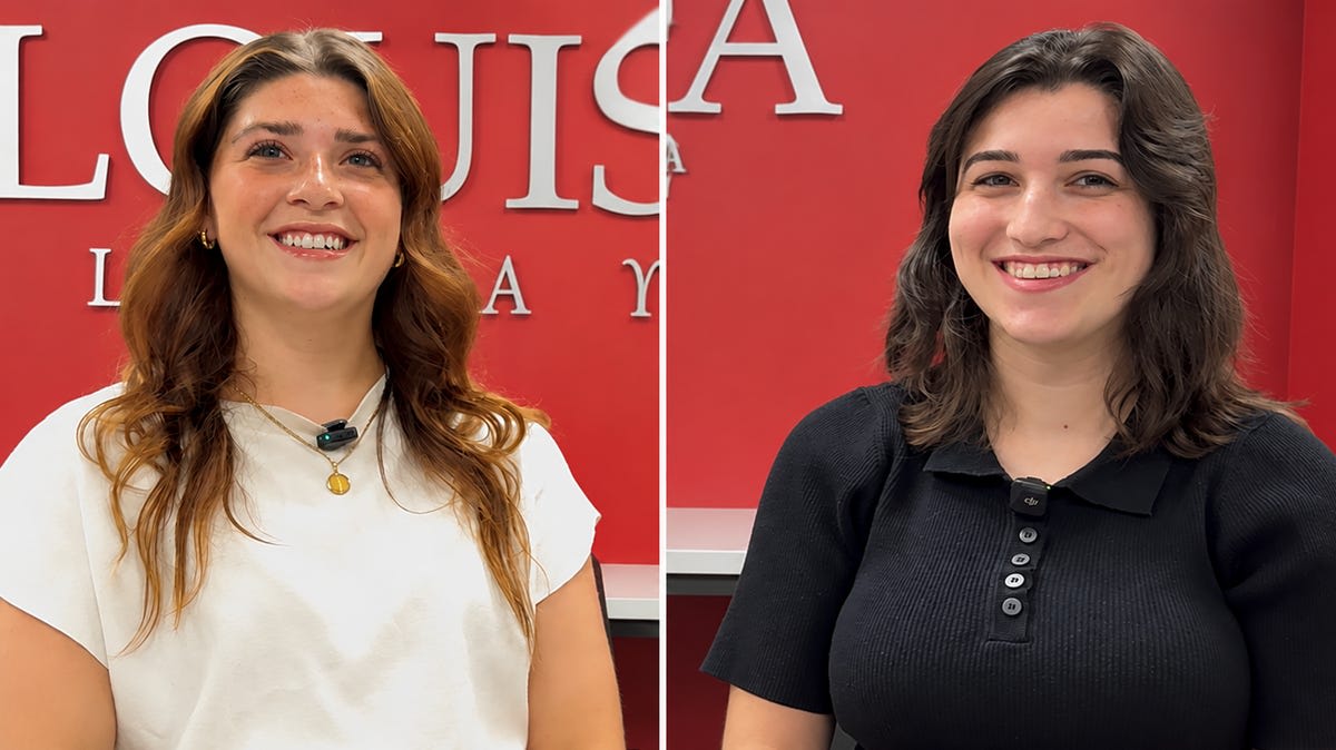 Two nursing students in scrubs smiling at University of Louisiana Lafayette campus