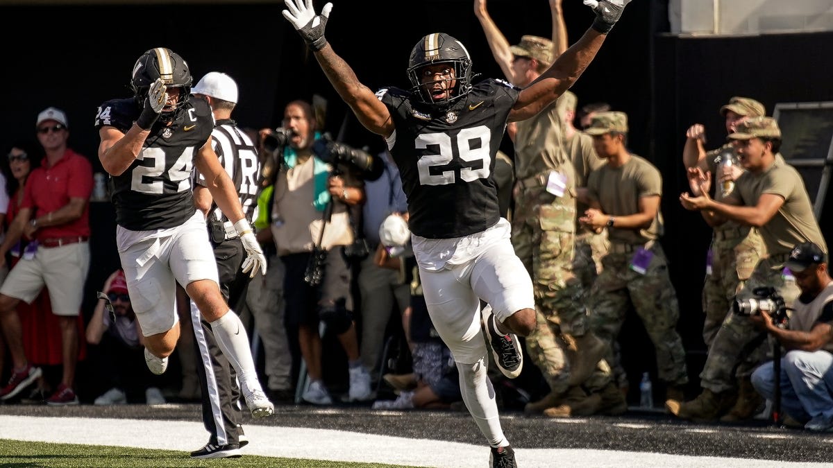 Vanderbilt football players celebrating dramatic last-second fumble recovery touchdown against NC State