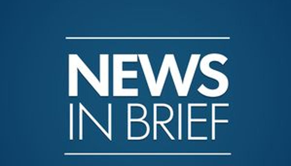 Students celebrating academic achievement with scholarship applications and college materials on desk