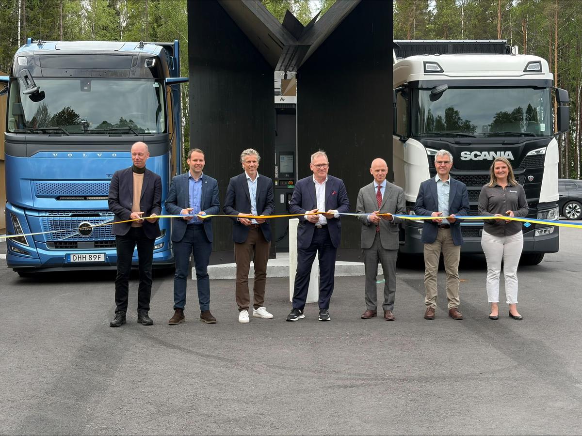 Modern hydrogen refueling station with green signage along Swedish highway for commercial trucks