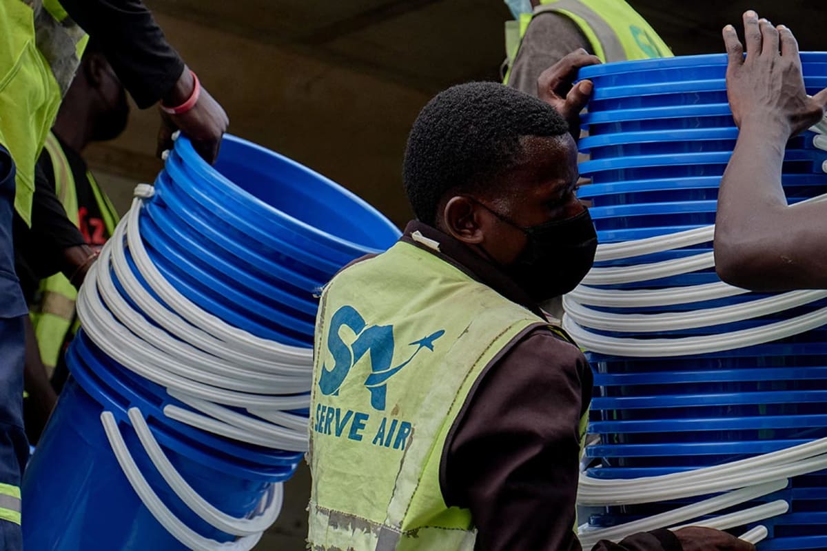 Health workers loading medical supplies onto transport vehicle in Democratic Republic of Congo