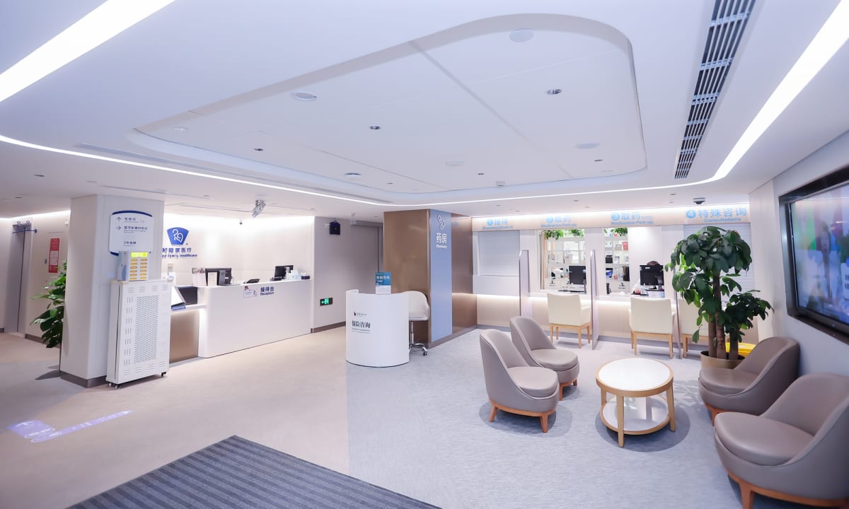 Patient Alex receiving cultural gift magnets from medical staff at Beijing hospital before discharge