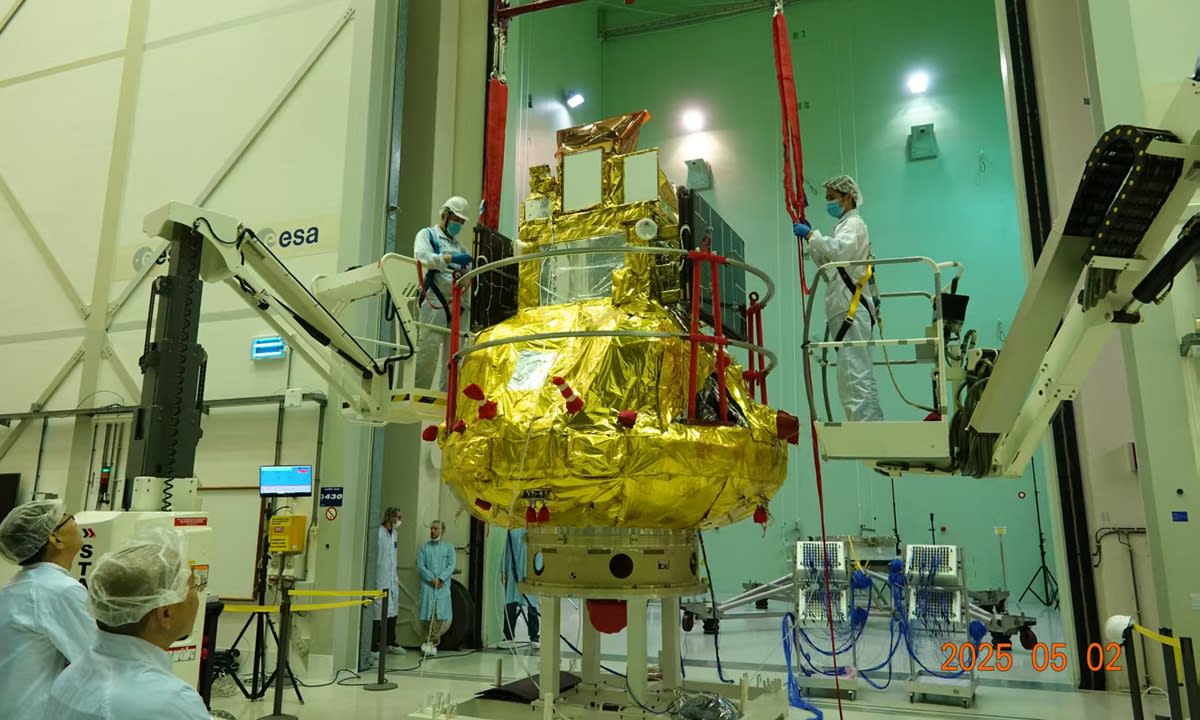 SMILE satellite with extended solar panels orbiting above Earth against black space