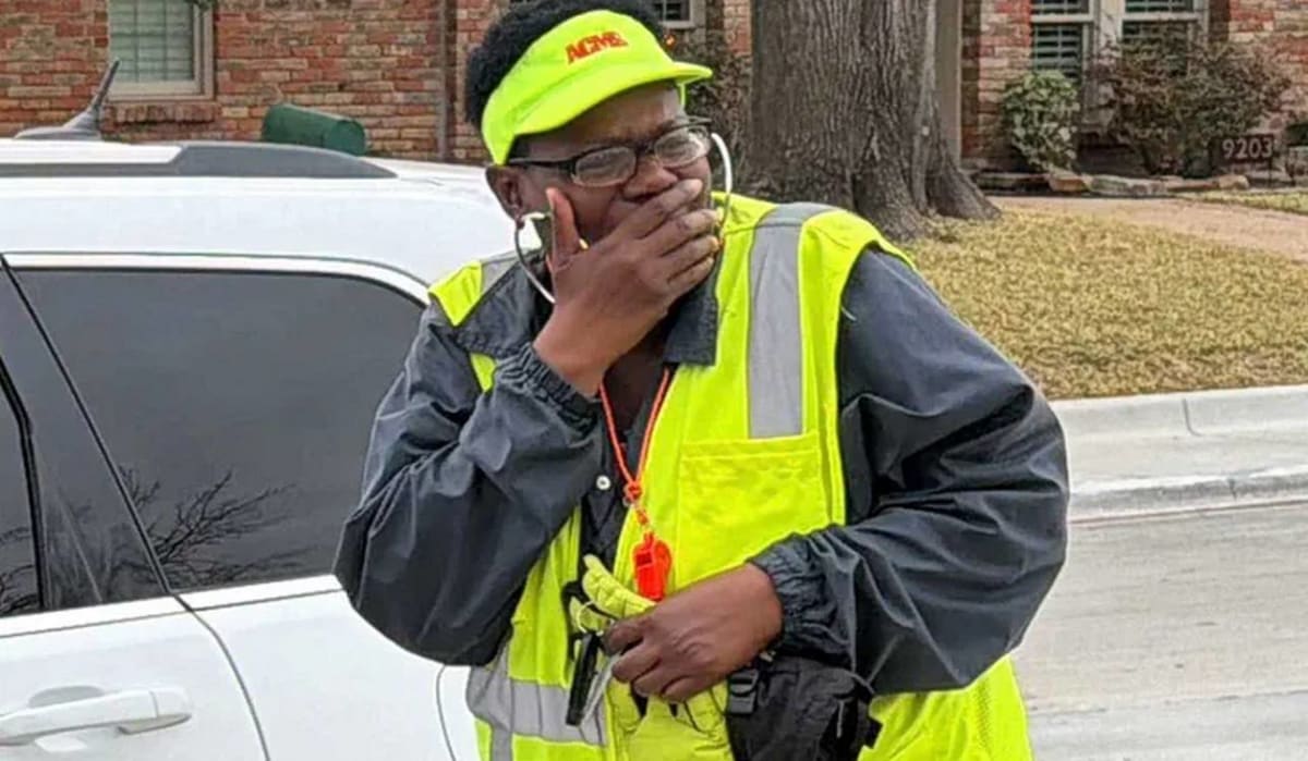 School crossing guard Ms. Trecia Crawford receiving car keys from group of smiling dads