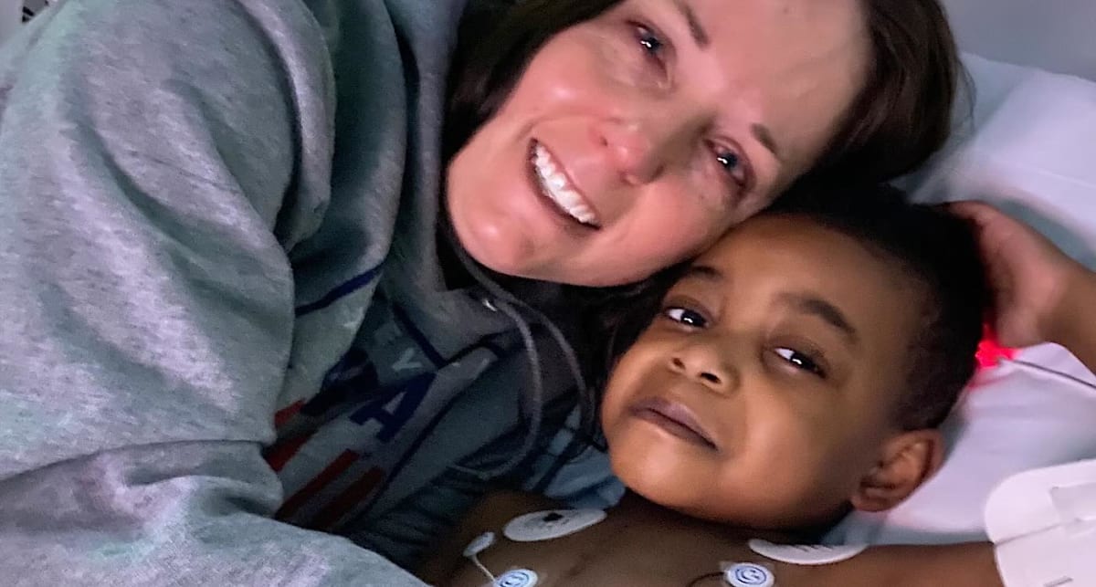Dr. Amy Beethe smiling with her adopted son True at Children's Nebraska hospital