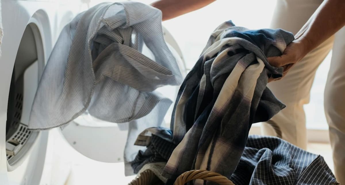 Mobile laundromat trailer with washers and dryers serving people on Philadelphia street corner